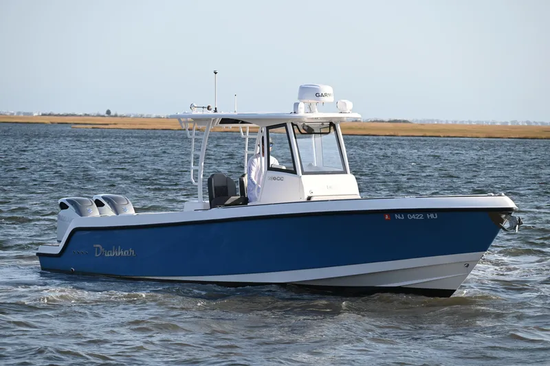 Slide: The Image of 2022 Drakkar 280 CC boat cruising on open water with dual engines. - 8