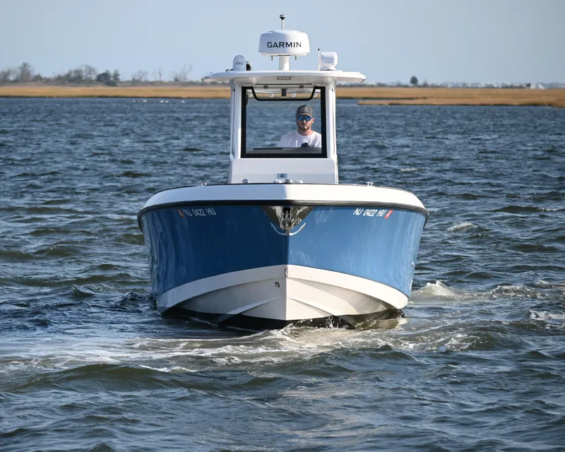 Slide: The Image of 2022 Drakkar 280 CC boat cruising on open water. - 9