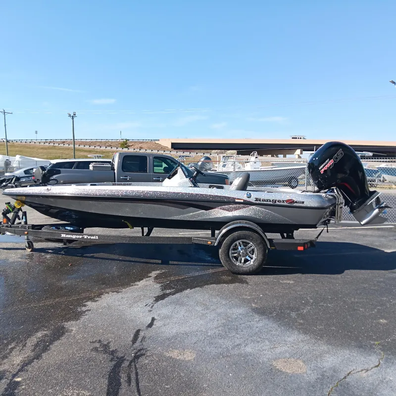 Slide: The Image of 2025 Ranger Z185 boat on trailer, parked outdoors under clear sky. - 0