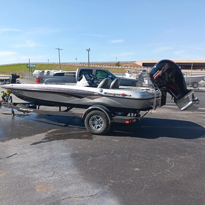 Slide: The Image of 2025 Ranger Z185 boat on trailer, parked outdoors under clear sky. - 1