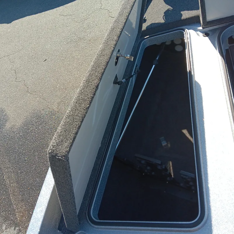 Slide: The Image of Open storage compartment on 2025 Ranger Z185 boat, showing interior details. - 10