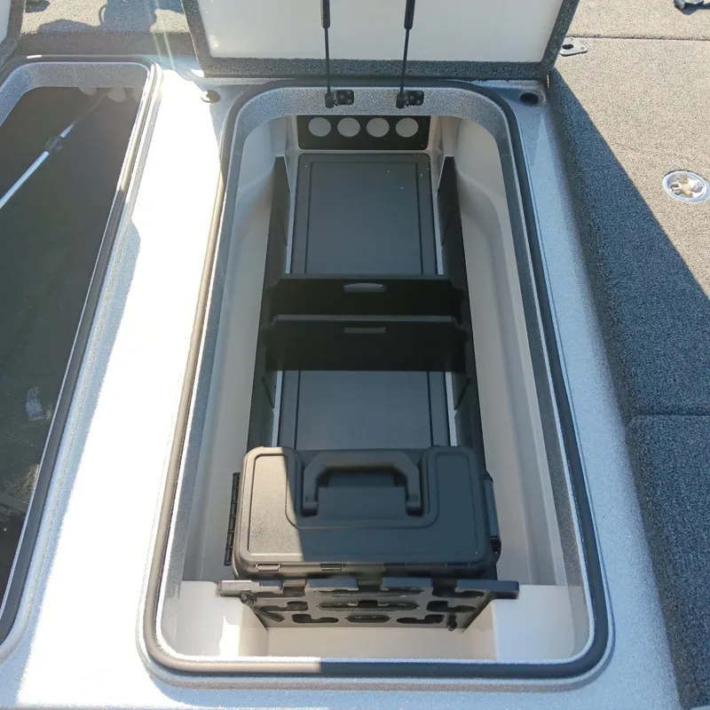 Slide: The Image of 2025 Ranger Z185 boat storage compartment with organized tackle box. - 11