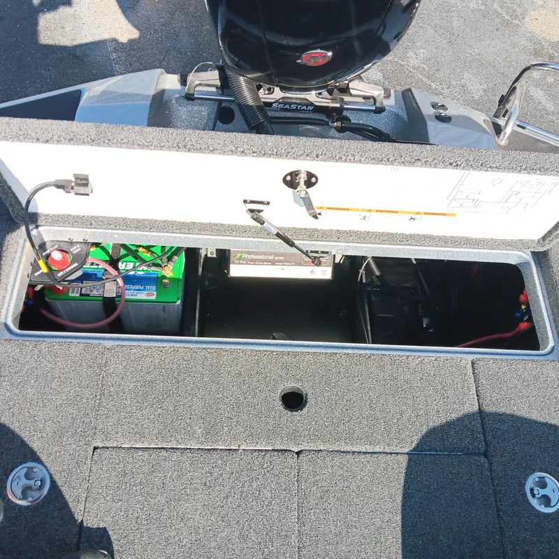 Slide: The Image of 2025 Ranger Z185 boat battery compartment with visible wiring and components. - 19