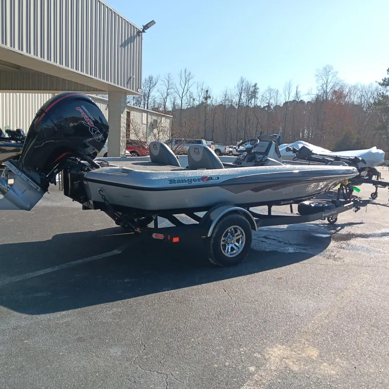 Slide: The Image of 2025 Ranger Z185 boat on trailer, parked outdoors, under clear sky. - 2