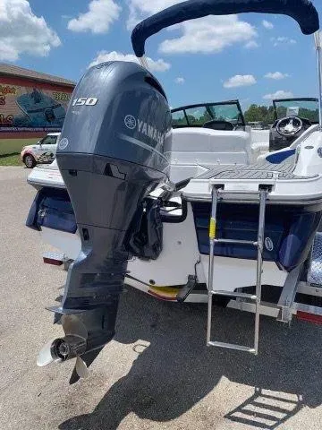 Slide: The Image of 2017 Monterey 197 Outboard boat with Yamaha 150 engine, ladder, and blue canopy. - 2