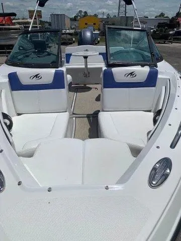 Slide: The Image of 2017 Monterey 197 Outboard boat with white and blue seating, open deck view. - 5