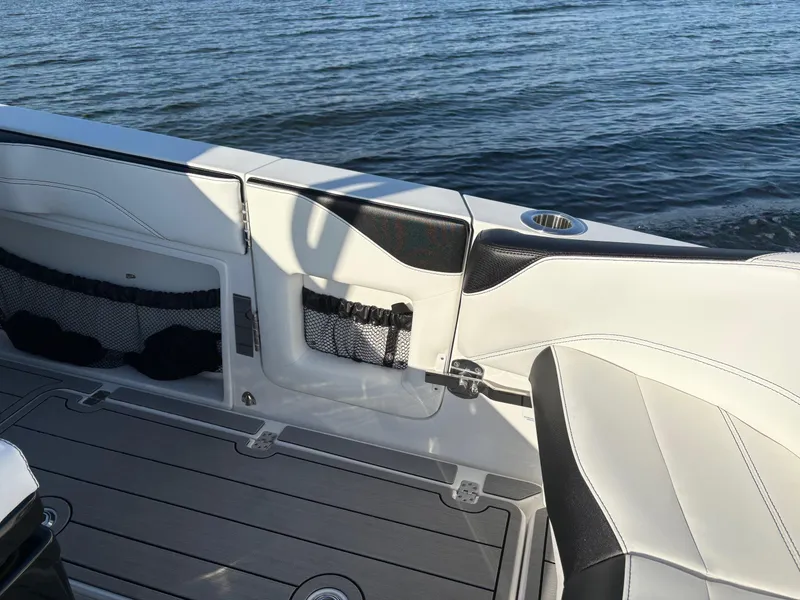 Slide: The Image of 2025 Nor-Tech 340 Sport boat interior with sleek seating and ocean backdrop. - 11