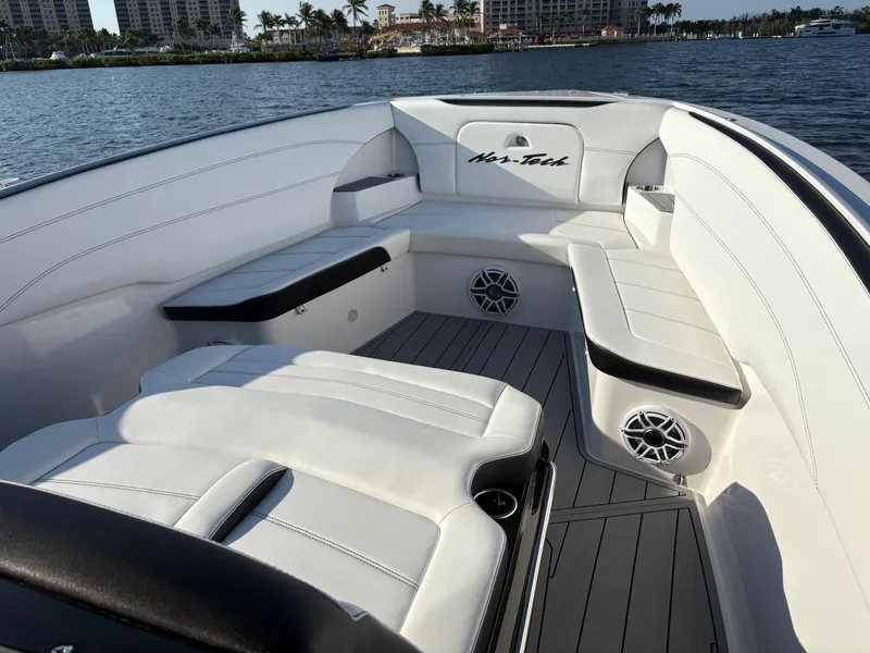 Slide: The Image of 2025 Nor-Tech 340 Sport boat interior with white seating and waterfront view. - 16
