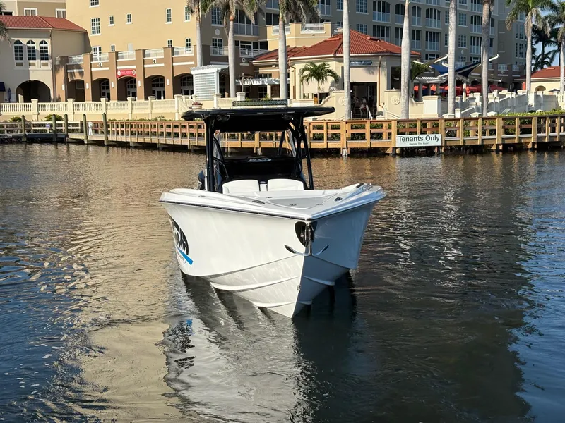 Slide: The Image of 2025 Nor-Tech 340 Sport boat on water near waterfront buildings. - 4