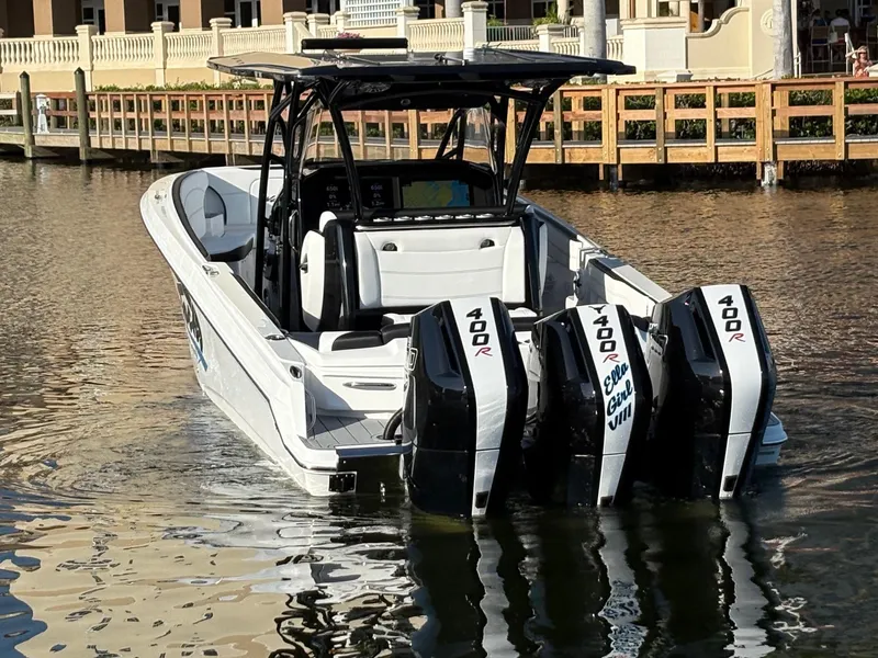 Slide: The Image of 2025 Nor-Tech 340 Sport boat with triple 400R engines on calm water. - 5