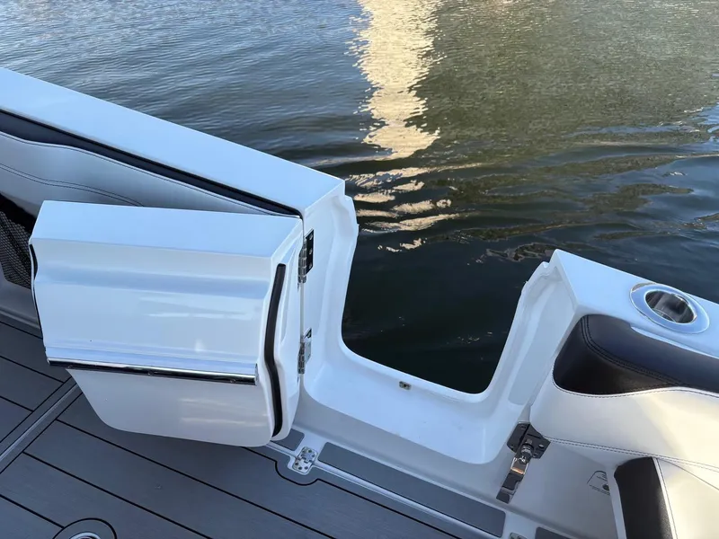 Slide: The Image of 2025 Nor-Tech 340 Sport boat with open side door, docked on calm water. - 7