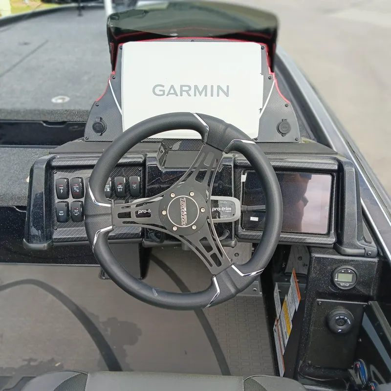 Slide: The Image of Steering wheel and dashboard of 2025 Triton 20XP Patriot boat with Garmin display. - 11