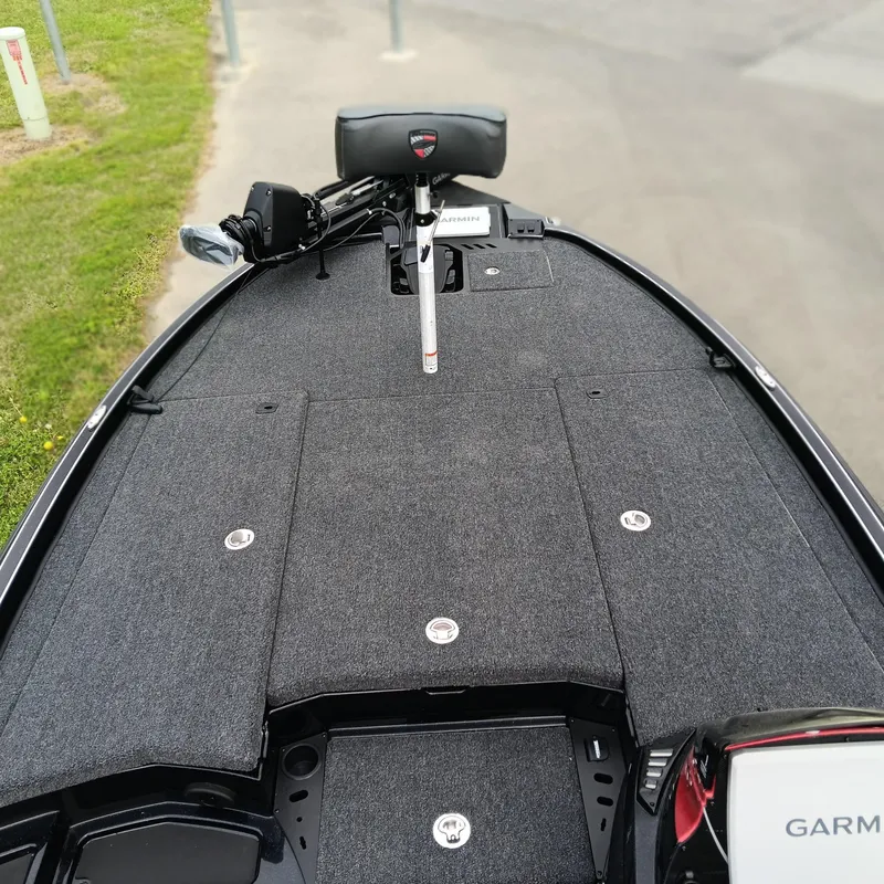 Slide: The Image of 2025 Triton 20XP Patriot boat deck with Garmin equipment, featuring a sleek, carpeted surface. - 6