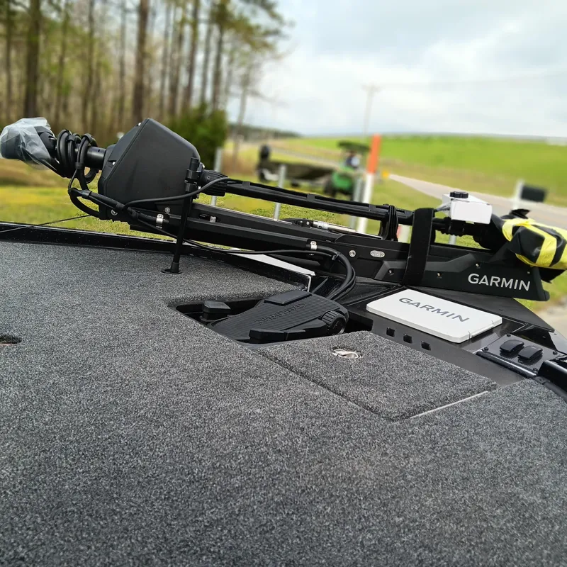 Slide: The Image of 2025 Triton 20XP Patriot boat with Garmin equipment on deck, outdoor setting. - 7