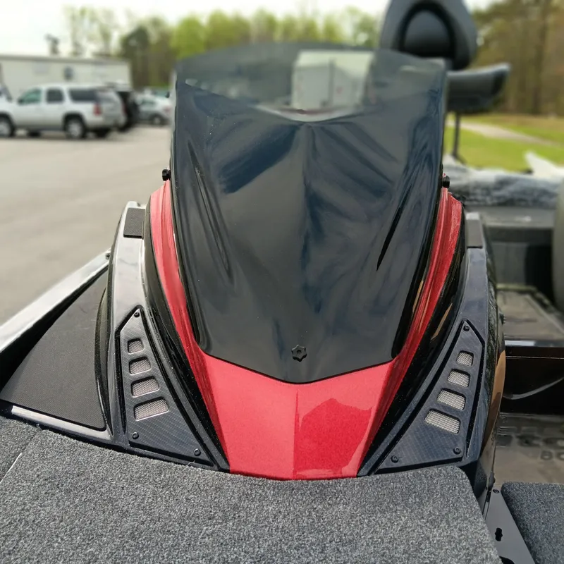 Slide: The Image of 2025 Triton 20XP Patriot boat with sleek red and black design, parked outdoors. - 8