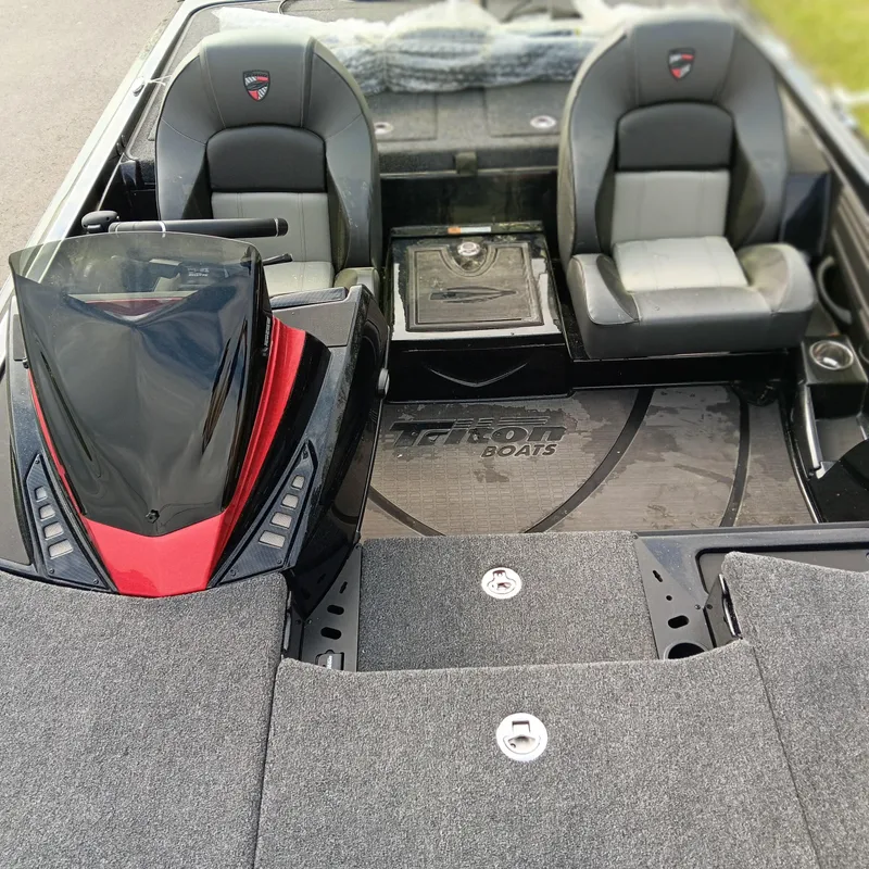 Slide: The Image of 2025 Triton 20XP Patriot boat interior with dual seats and sleek design. - 9