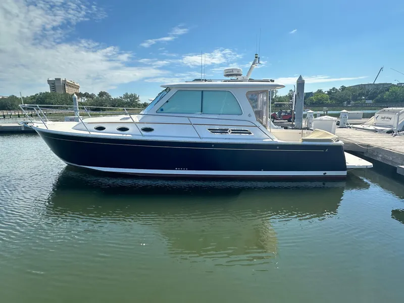 Slide: The Image of 2013 Back Cove 34 boat docked in marina under clear blue sky. - 1