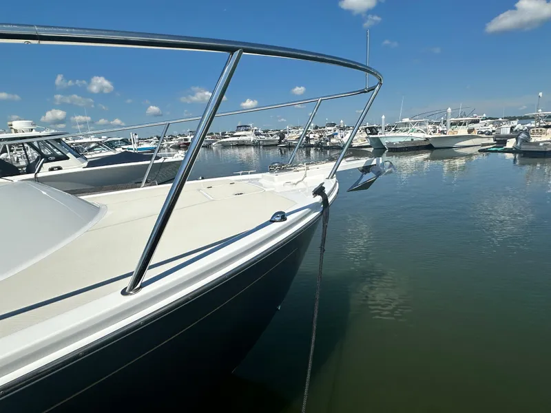 Slide: The Image of 2013 Back Cove 34 boat docked in a marina under a clear blue sky. - 10