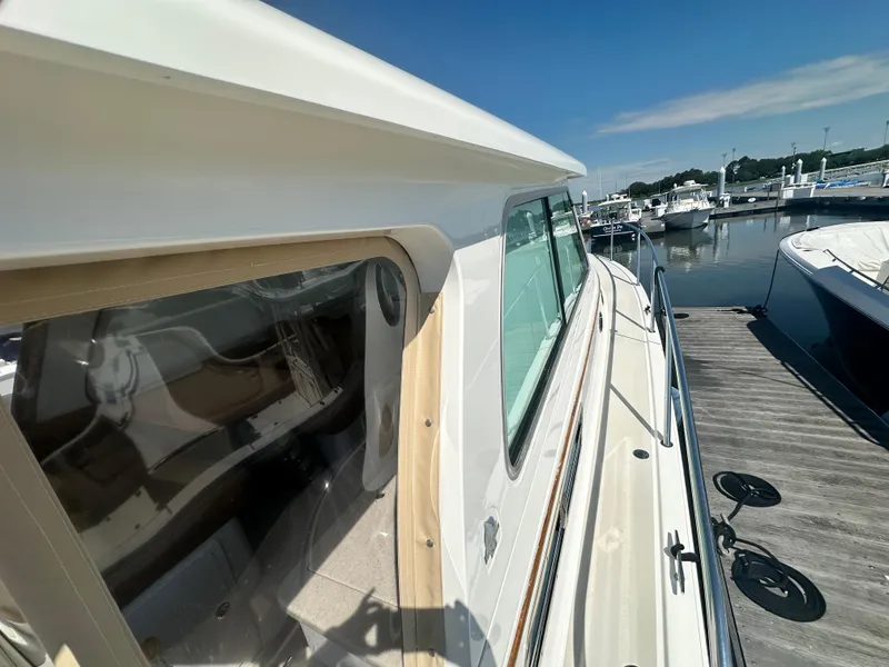 Slide: The Image of 2013 Back Cove 34 yacht docked at marina under clear blue sky. - 13