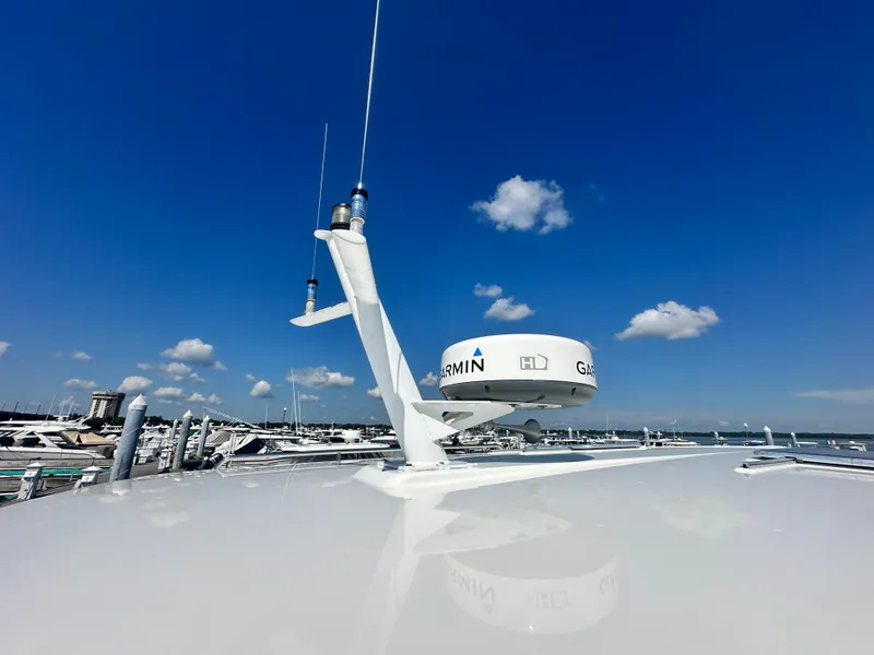 Slide: The Image of 2013 Back Cove 34 boat with Garmin radar against a clear blue sky. - 14