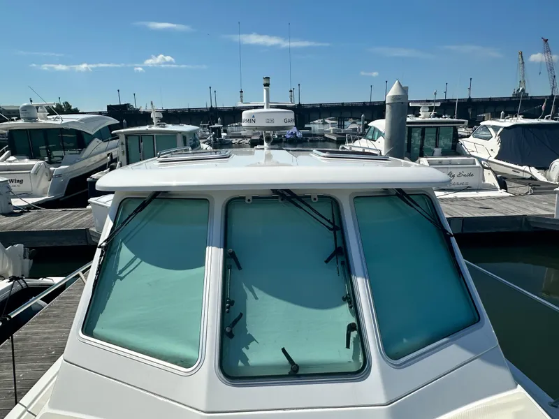 Slide: The Image of 2013 Back Cove 34 boat docked at marina under clear blue sky. - 18