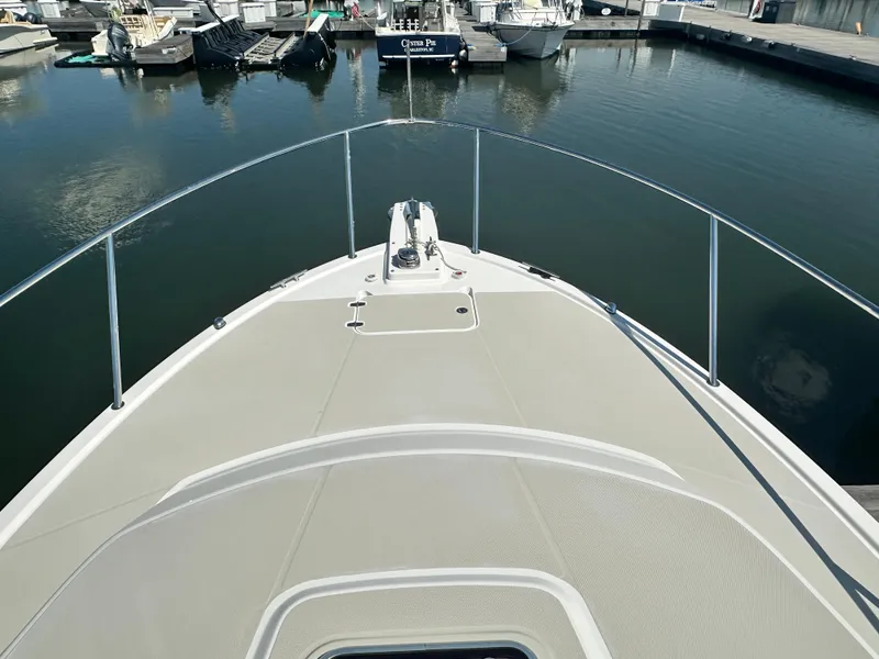 Slide: The Image of Bow view of 2013 Back Cove 34 boat docked in a marina. - 19