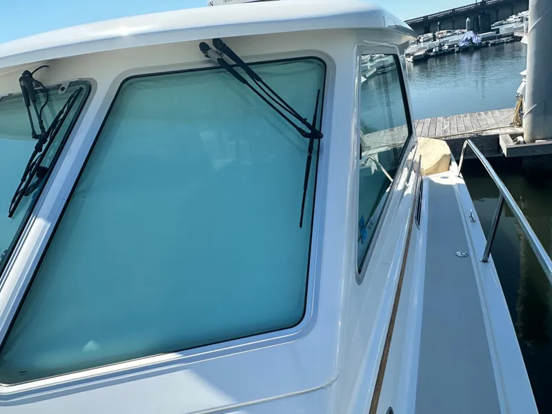 Slide: The Image of 2013 Back Cove 34 boat with sleek windows and dockside view. - 24