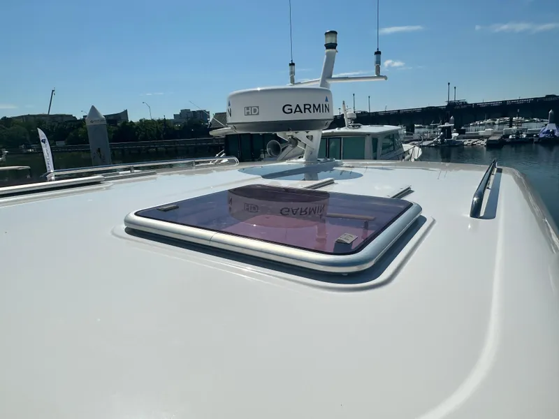 Slide: The Image of 2013 Back Cove 34 yacht with Garmin radar, docked under clear skies. - 26