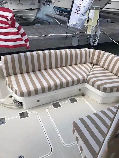 Slide: The Image of 2013 Back Cove 34 boat with striped seating on deck. - 28