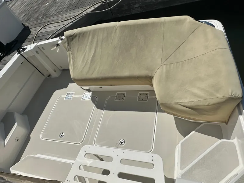 Slide: The Image of 2013 Back Cove 34 boat deck with beige seating and storage compartments. - 29