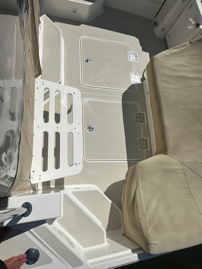 Slide: The Image of 2013 Back Cove 34 boat deck with beige seating and storage compartments. - 30