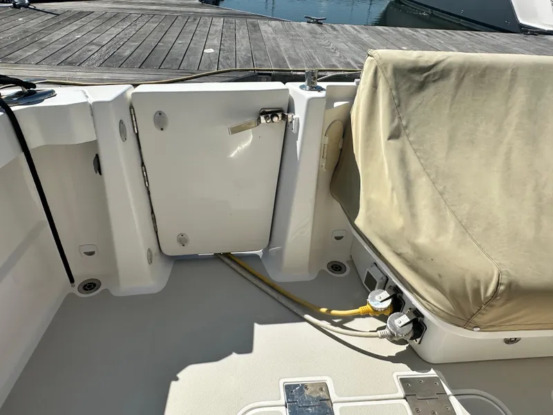 Slide: The Image of 2013 Back Cove 34 boat deck with covered seating and dockside power connections. - 32