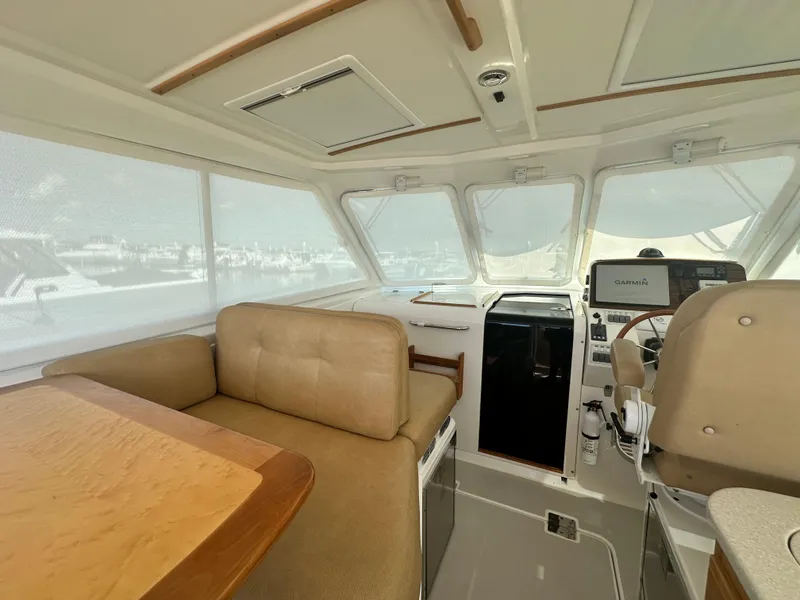Slide: The Image of Interior of a 2013 Back Cove 34 boat with seating and helm station. - 35