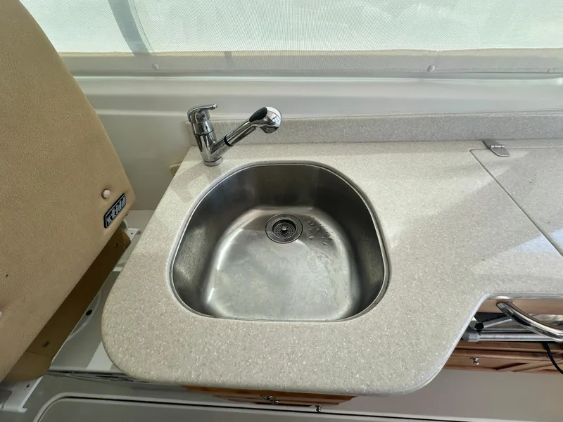Slide: The Image of 2013 Back Cove 34 boat kitchen sink with modern faucet and countertop. - 39