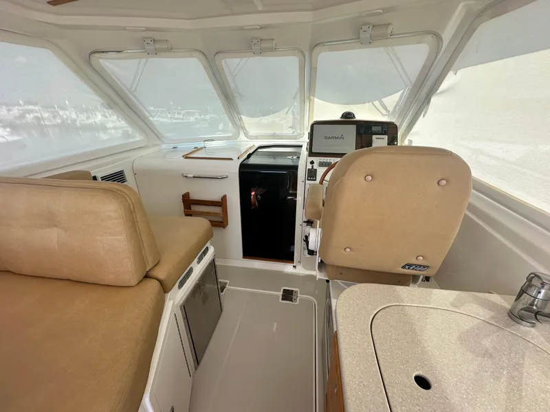 Slide: The Image of 2013 Back Cove 34 interior with helm, seating, and navigation equipment. - 40