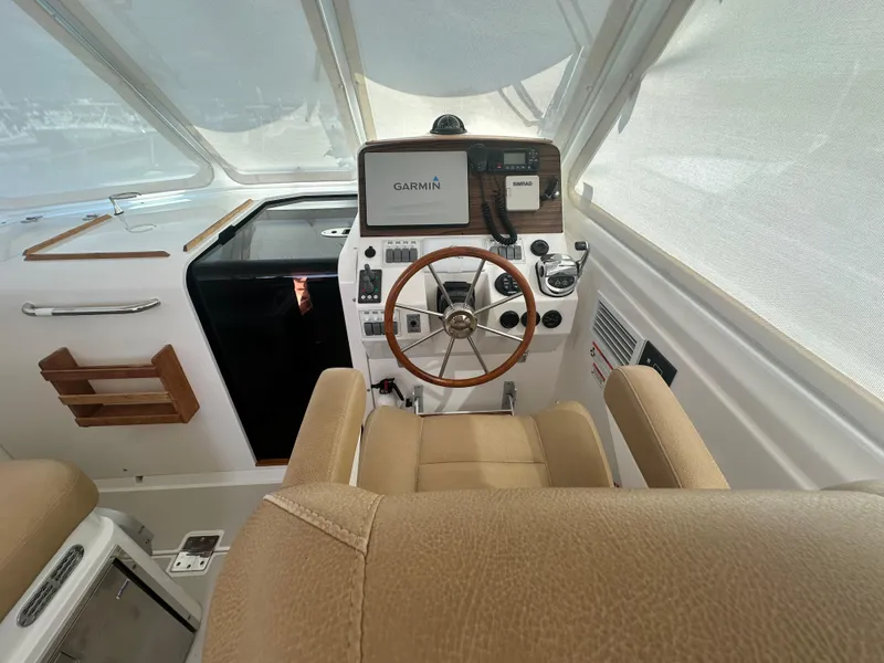 Slide: The Image of Helm of 2013 Back Cove 34 boat with Garmin navigation system and wooden steering wheel. - 41