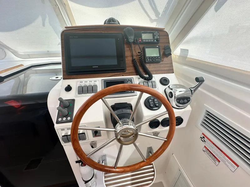 Slide: The Image of Helm of 2013 Back Cove 34 boat with steering wheel and navigation equipment. - 45