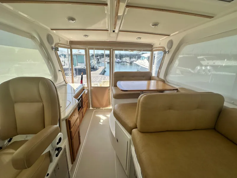 Slide: The Image of Interior of 2013 Back Cove 34 yacht with beige seating and wooden table. - 48