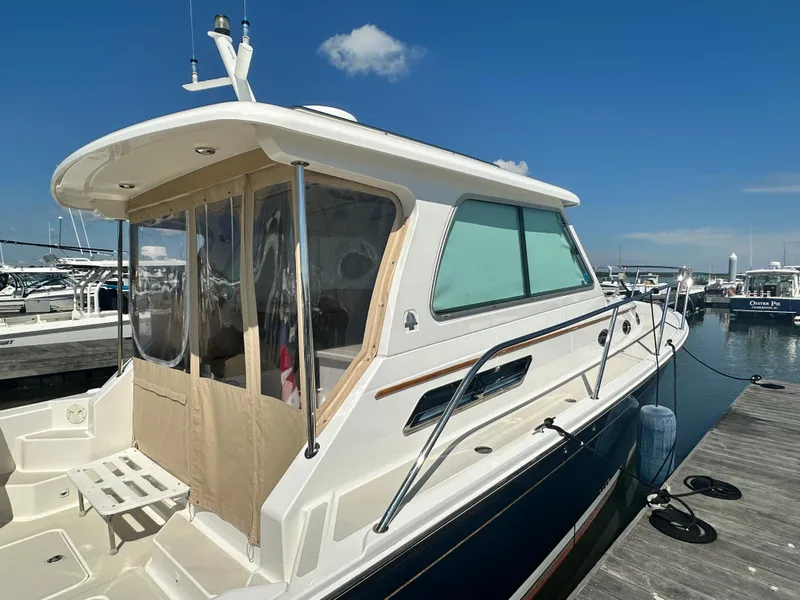 Slide: The Image of 2013 Back Cove 34 boat docked at marina under clear blue sky. - 5