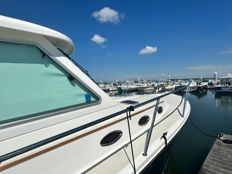 Slide: The Image of 2013 Back Cove 34 boat docked at marina under clear blue sky. - 8