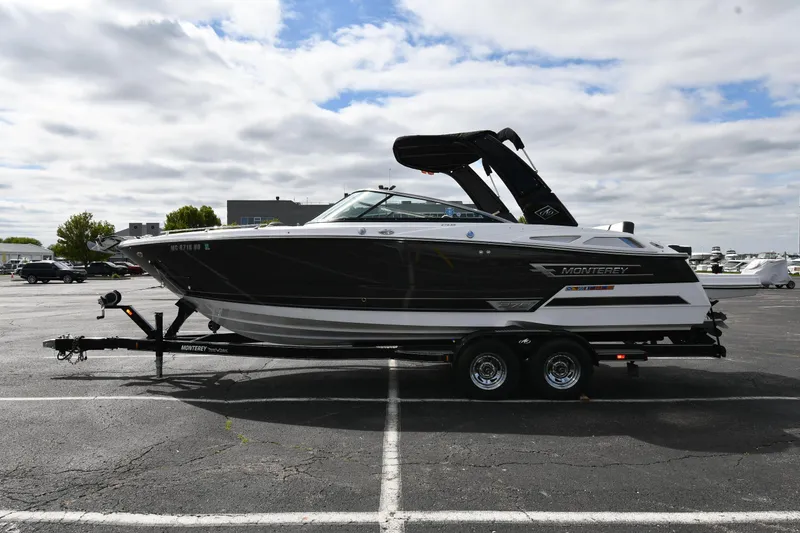 Slide: The Image of 2023 Monterey 278 Super Sport boat on trailer in parking lot under cloudy sky. - 0