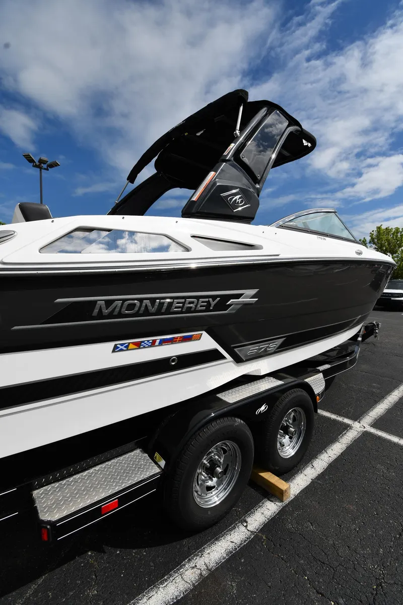Slide: The Image of 2023 Monterey 278 Super Sport boat on trailer under blue sky. - 2
