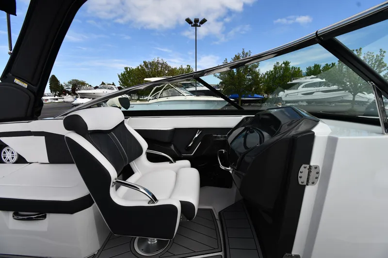 Slide: The Image of 2023 Monterey 278 Super Sport boat interior with sleek black and white seating. - 23