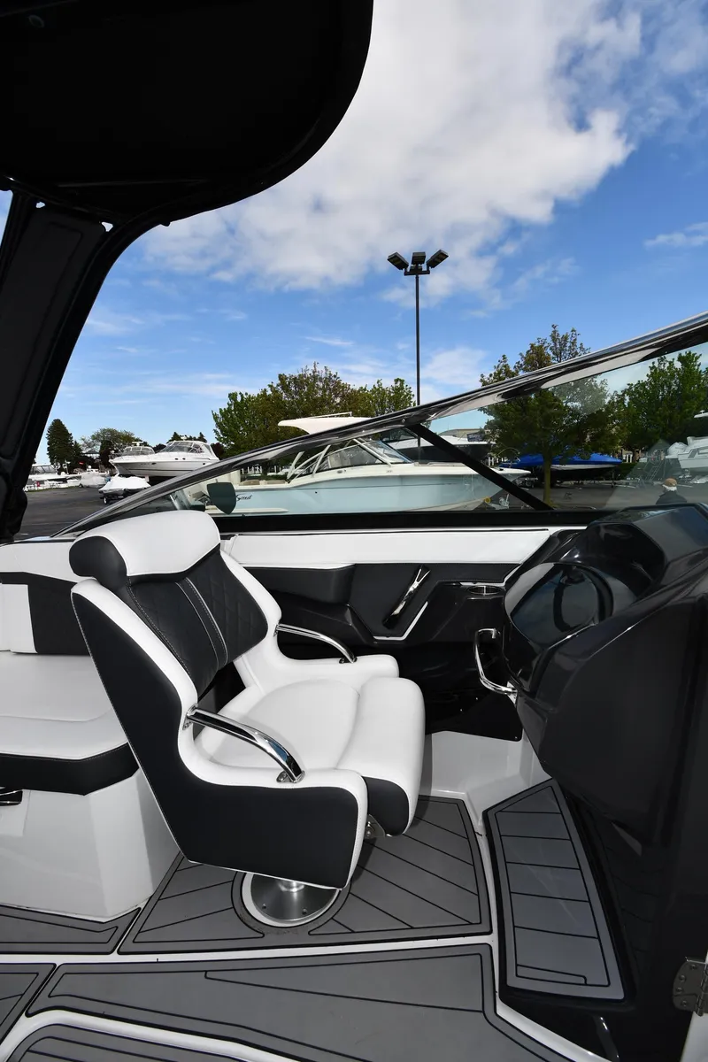 Slide: The Image of 2023 Monterey 278 Super Sport boat interior with sleek seating and modern dashboard design. - 24