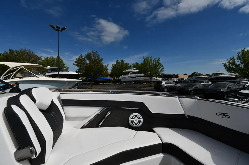 Slide: The Image of 2023 Monterey 278 Super Sport boat interior with sleek seating, parked among other boats. - 37