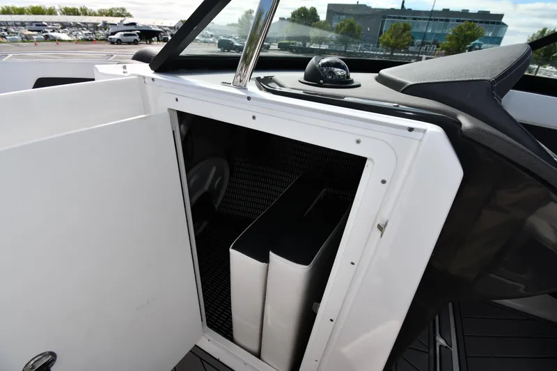 Slide: The Image of 2023 Monterey 278 Super Sport boat storage compartment with open door, showcasing interior space. - 42