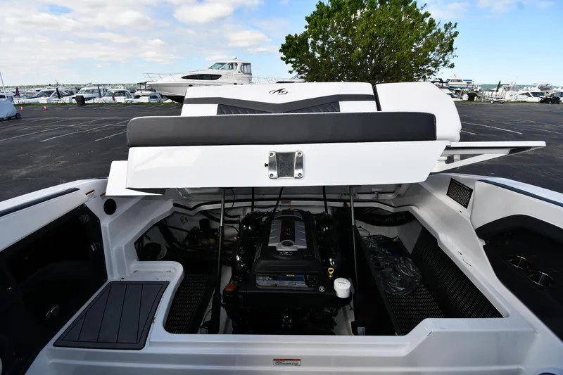 Slide: The Image of 2023 Monterey 278 Super Sport boat engine compartment with open hatch, showcasing engine details. - 44