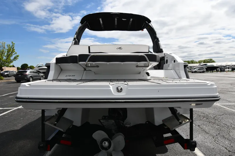 Slide: The Image of 2023 Monterey 278 Super Sport boat, rear view, parked outdoors under cloudy sky. - 7