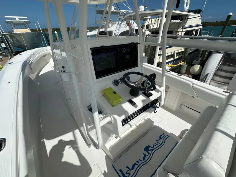 Slide: The Image of 2006 Island Runner 35 boat cockpit with steering wheel and navigation equipment. - 13