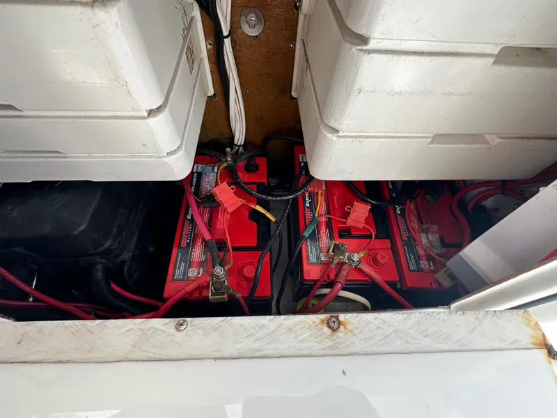 Slide: The Image of Battery compartment of a 2006 Island Runner 35 boat, featuring red marine batteries. - 17